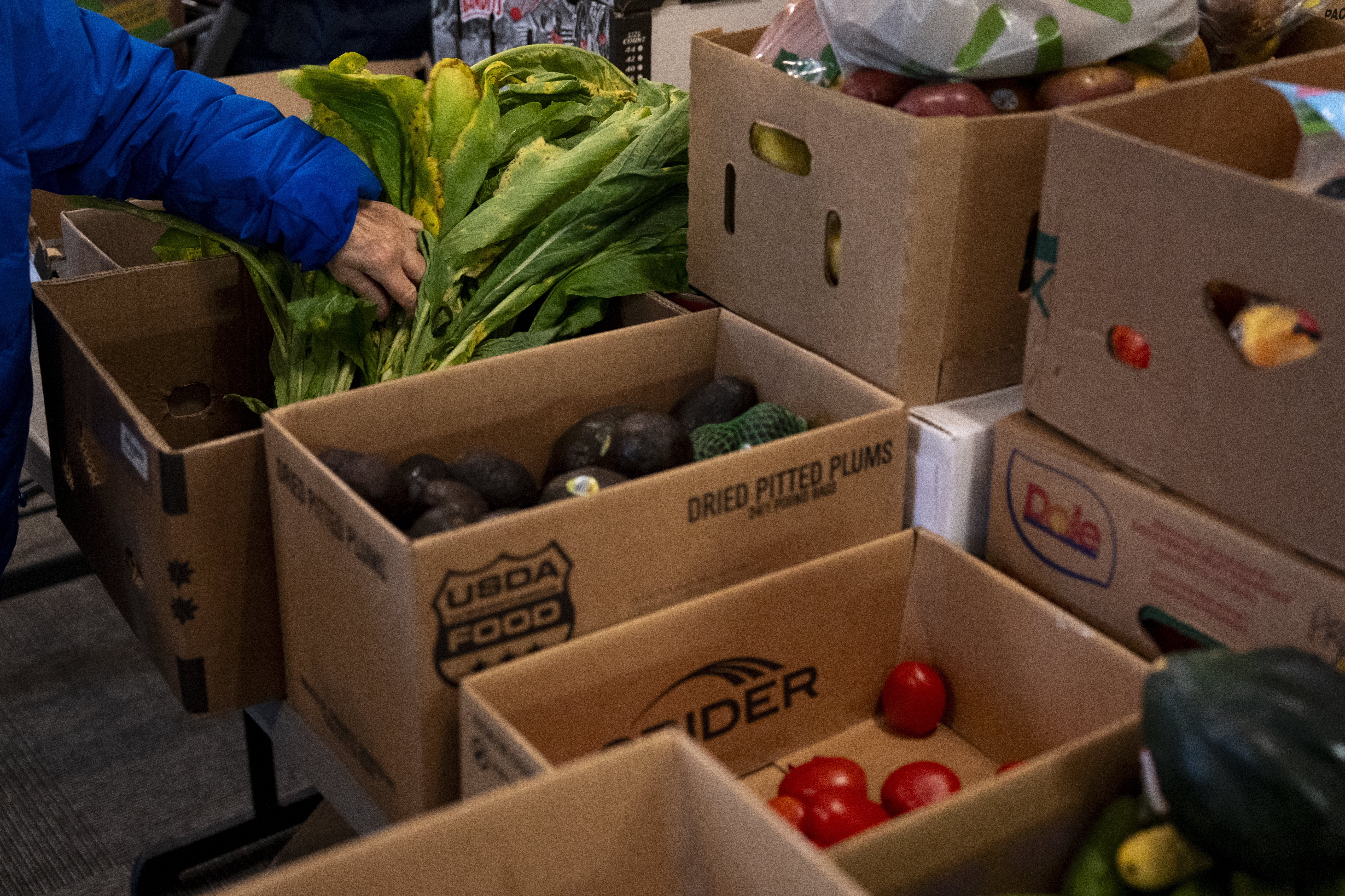 A person picks out greens at One Life Food Pantry, located in Real Life Foursquare Church in Vancouver, Wash., on Nov. 1, 2025.